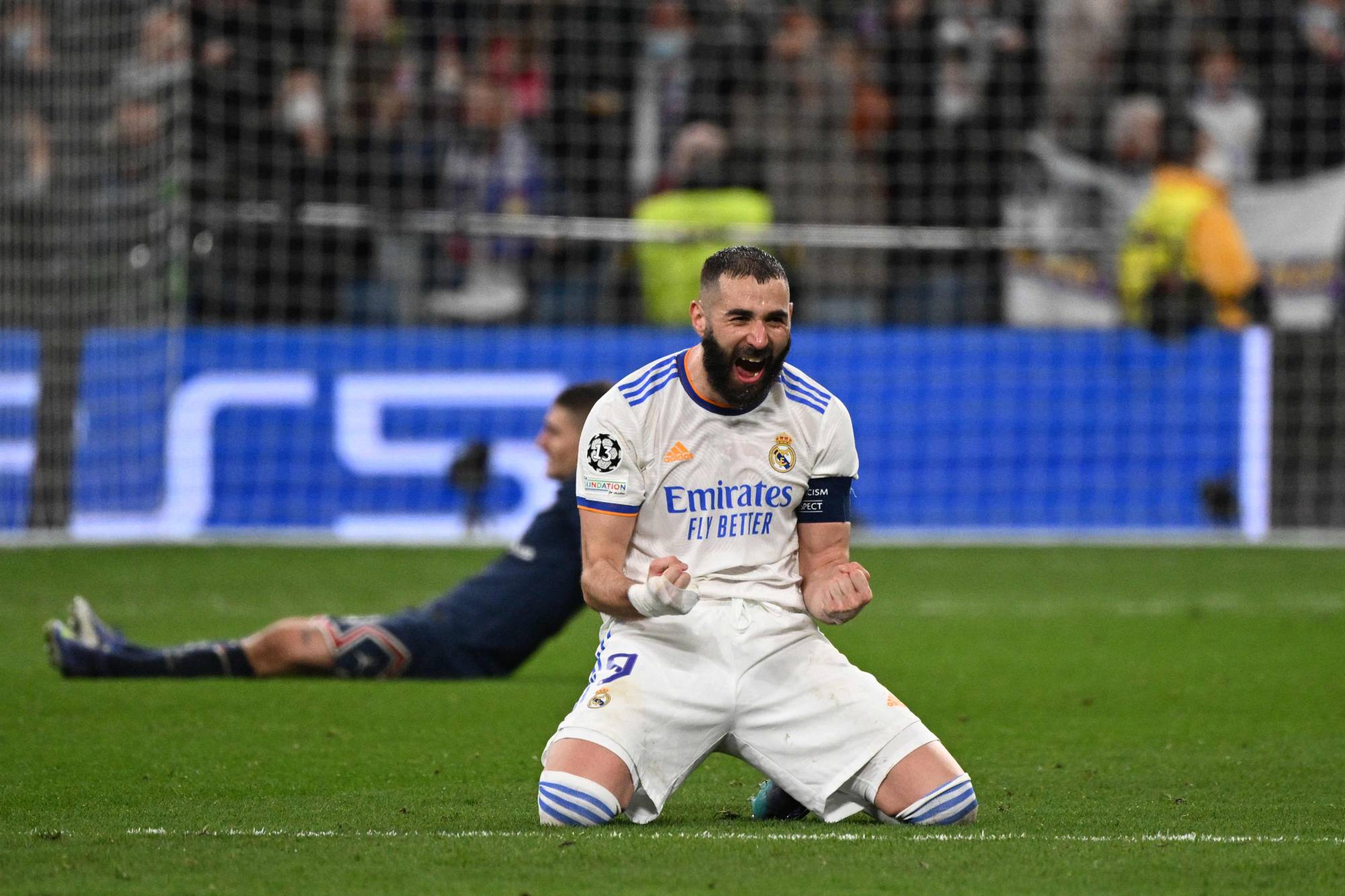 Real Madrid's French forward Karim Benzema celebrates after scoring a goal during the UEFA Champions League round of 16 second league football match between Real Madrid CF and Paris Saint-Germain at the Santiago Bernabeu stadium in Madrid on March 9, 2022. (Photo by GABRIEL BOUYS / AFP)